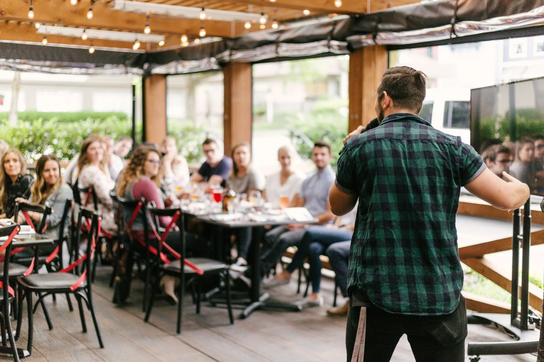Company gathering with a presenter speaking to a seated audience